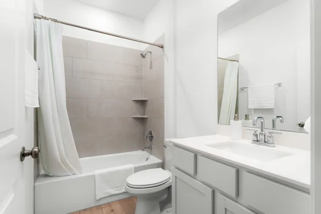 a bathroom with a sink toilet and shower