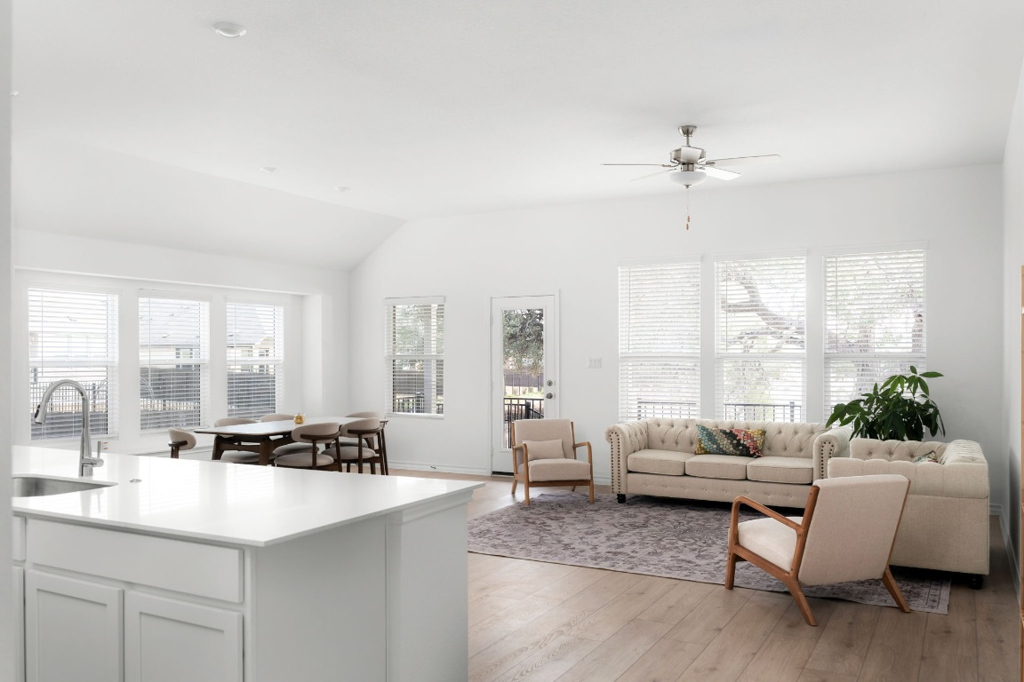 4264 Hill House Lane Georgetown, TX 78628 - Photo 4 of 30 Living area with light wood-style floors, lofted ceiling, and ceiling fan