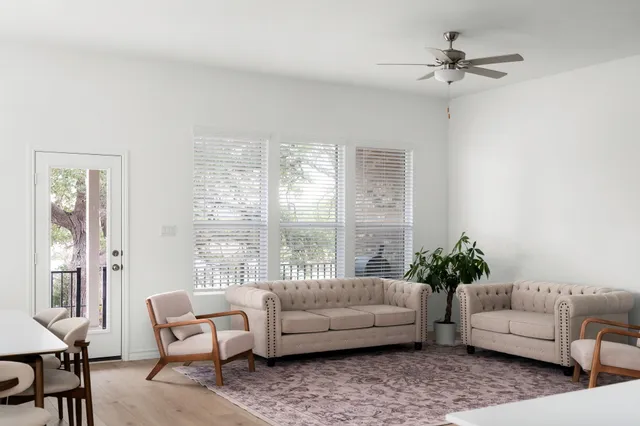 a living room with furniture and a large window