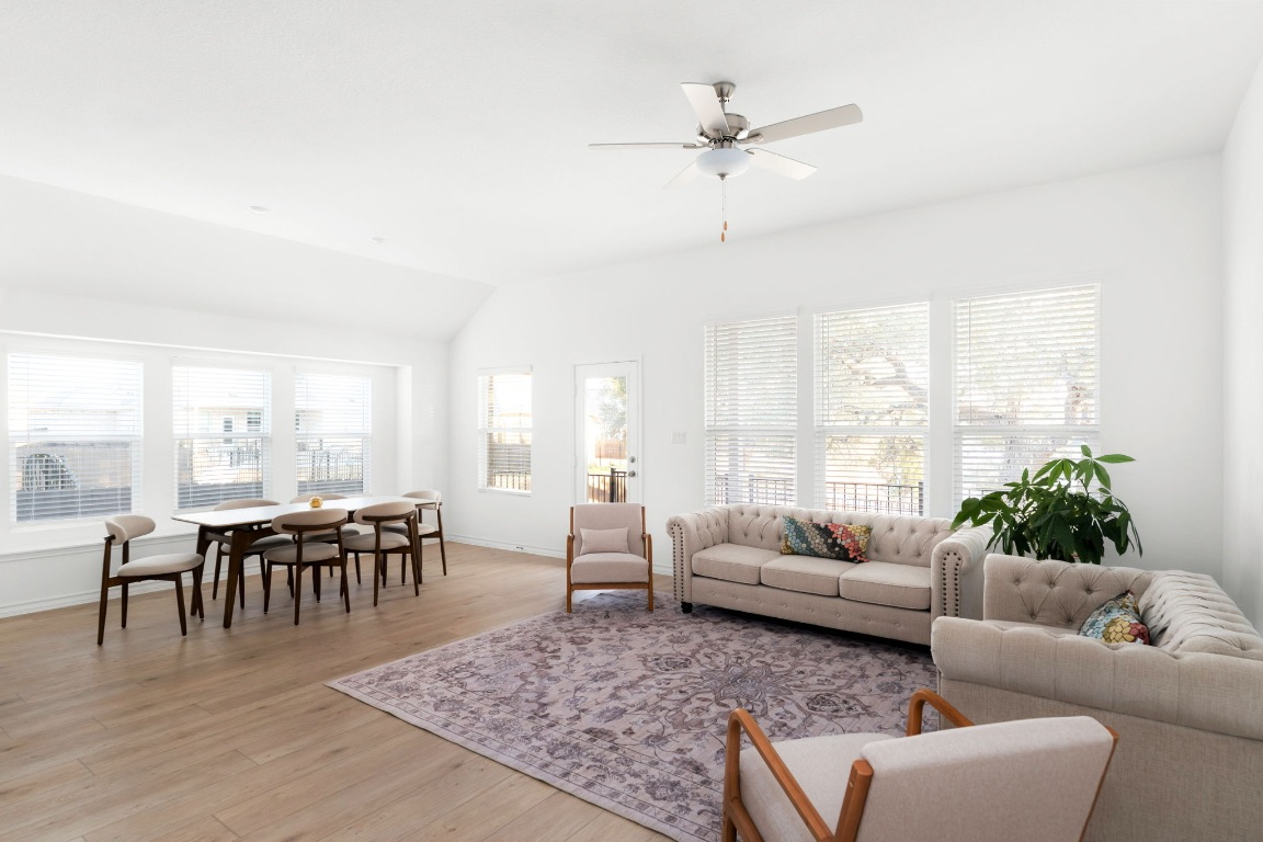4264 Hill House Lane Georgetown, TX 78628 - Photo 10 of 30 Living room featuring light wood-type flooring, lofted ceiling, and a ceiling fan