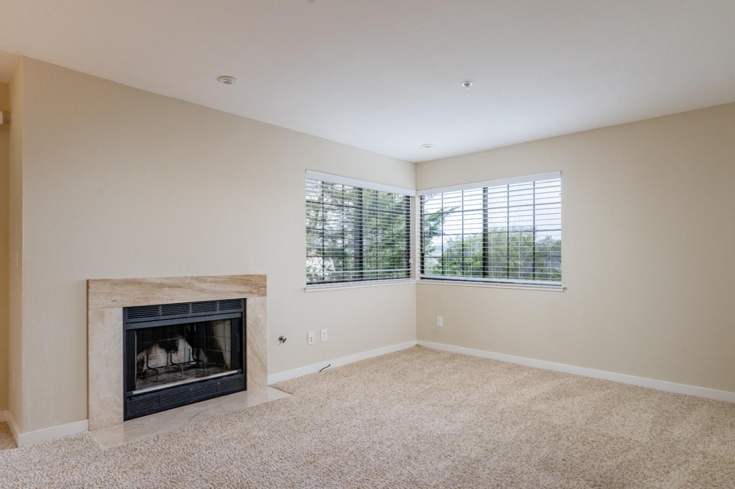 710 Pheasant Ridge Road Del Rey Oaks, CA 93940 - Photo 14 of 35 an empty room with a fireplace and window