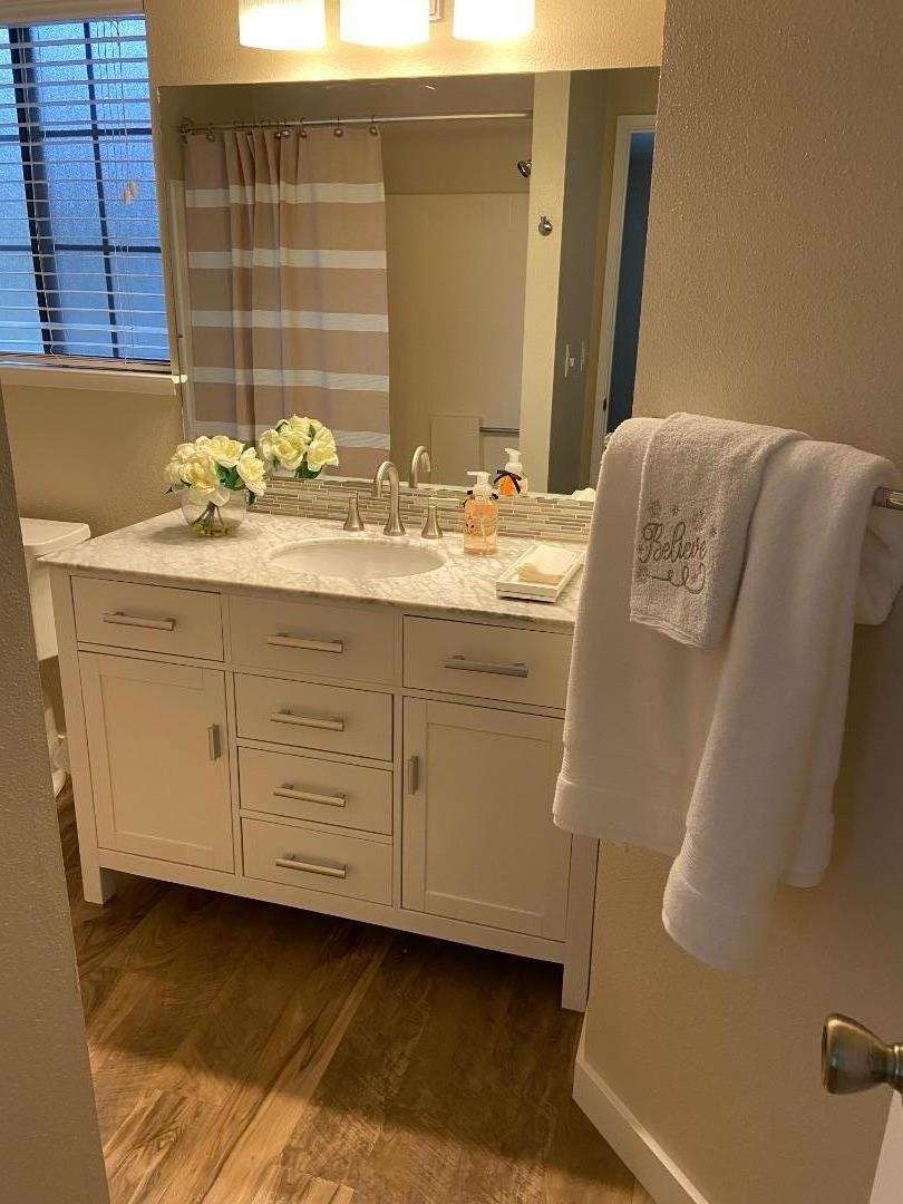 710 Pheasant Ridge Road Del Rey Oaks, CA 93940 - Photo 24 of 35 a bathroom with a granite countertop sink and a mirror