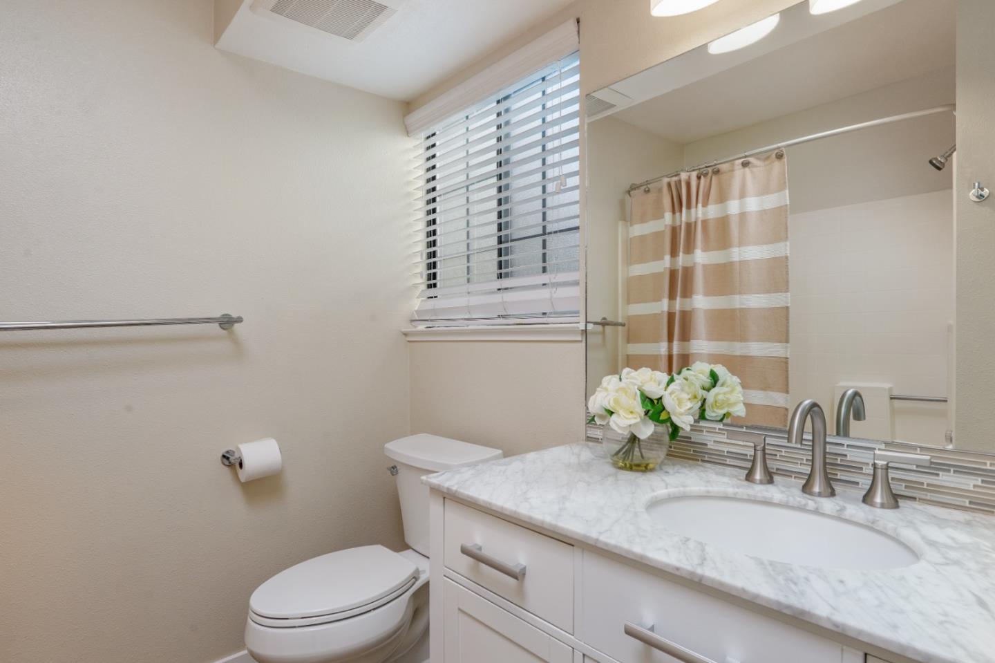 710 Pheasant Ridge Road Del Rey Oaks, CA 93940 - Photo 25 of 35 a bathroom with a granite countertop sink a toilet and mirror