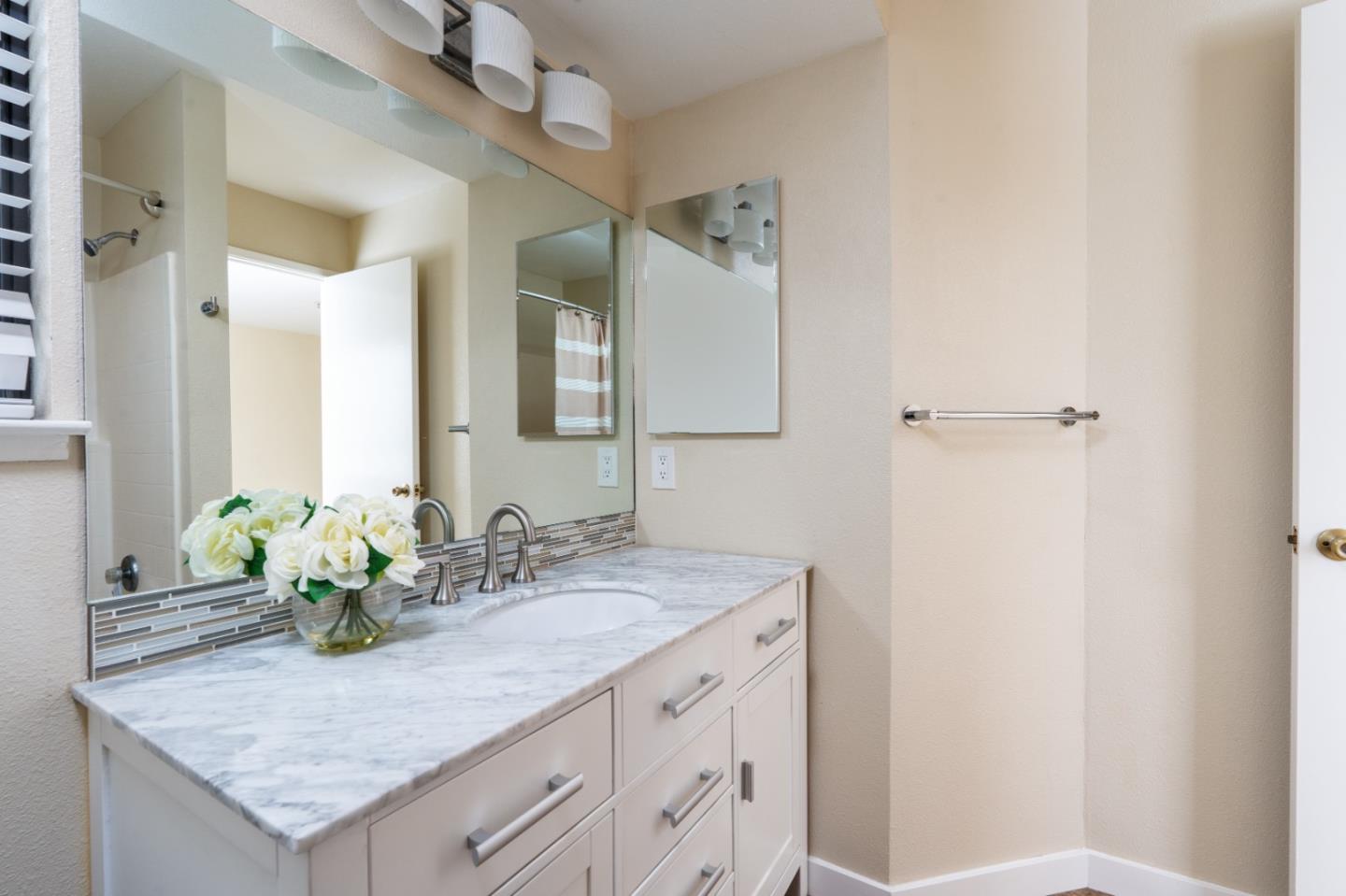 710 Pheasant Ridge Road Del Rey Oaks, CA 93940 - Photo 26 of 35 a bathroom with a granite countertop sink and a mirror