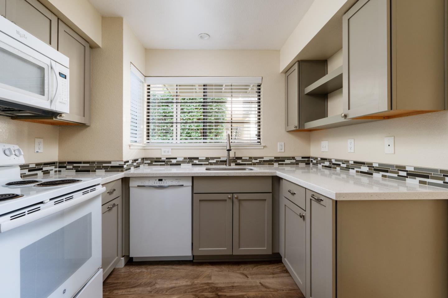 710 Pheasant Ridge Road Del Rey Oaks, CA 93940 - Photo 3 of 35 a kitchen with stainless steel appliances granite countertop a stove a sink and a microwave