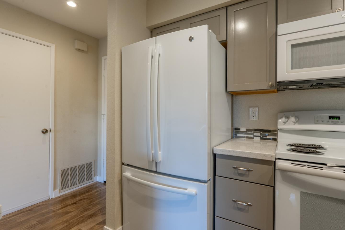 710 Pheasant Ridge Road Del Rey Oaks, CA 93940 - Photo 6 of 35 a kitchen with a refrigerator sink and cabinets