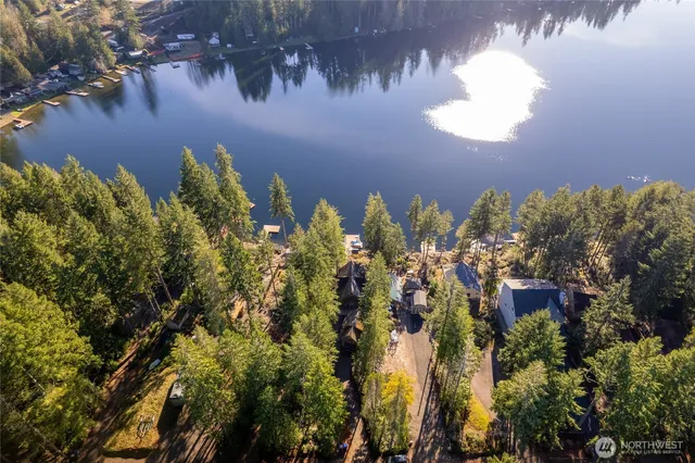 a view of a lake with trees in front of it