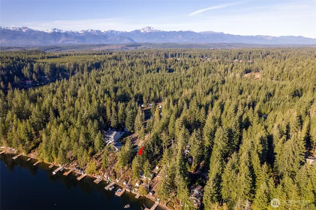 a hallway with a door and a view of bedroom