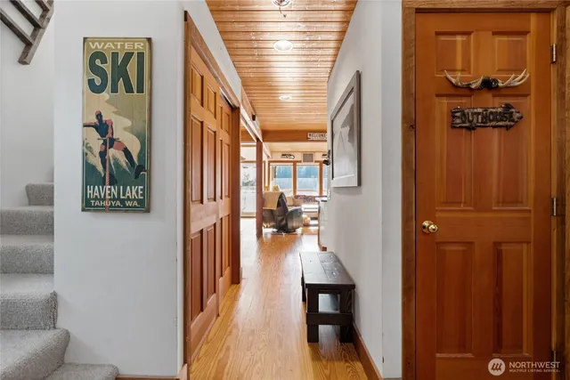 a living room with furniture a flat screen tv and a floor to ceiling window