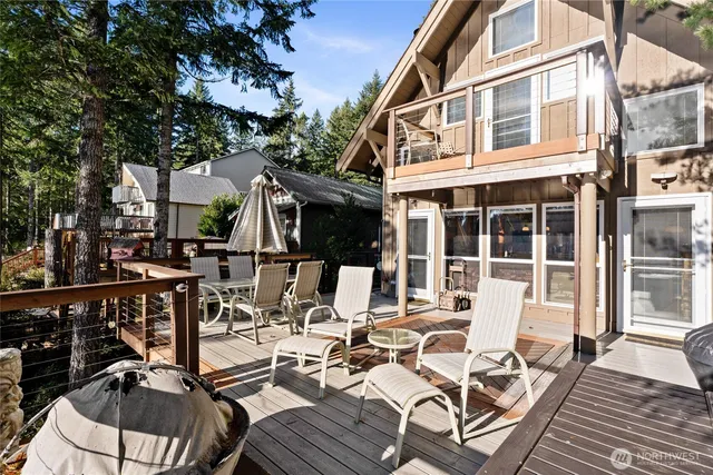 a view of a patio with table and chairs and wooden floor