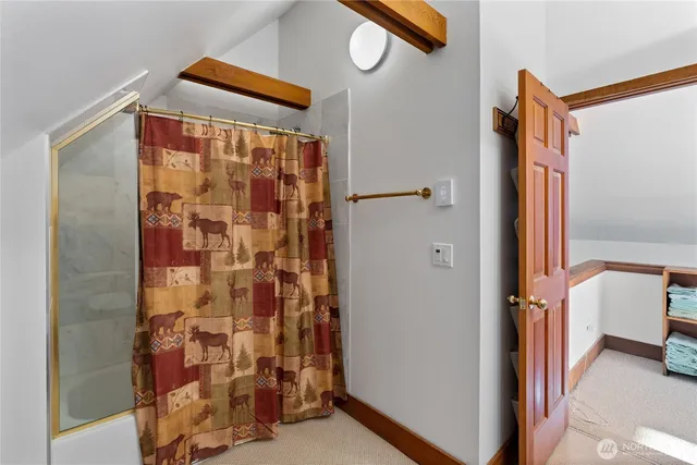 a view of barn house with a small yard and large trees