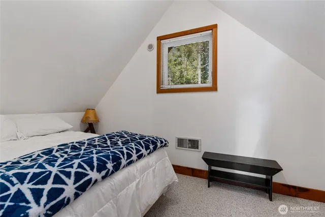 a bedroom with a bed and a couch