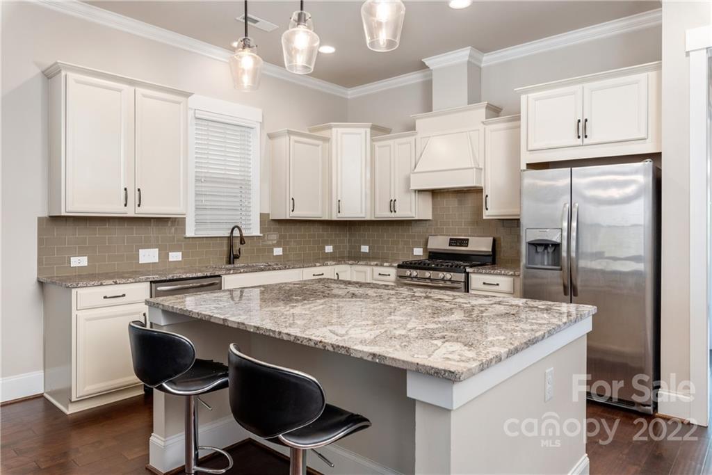 807 Digby Road, Unit 227 Rock Hill, SC 29730 - Photo 16 of 36 a kitchen with stainless steel appliances granite countertop a stove refrigerator sink and cabinets