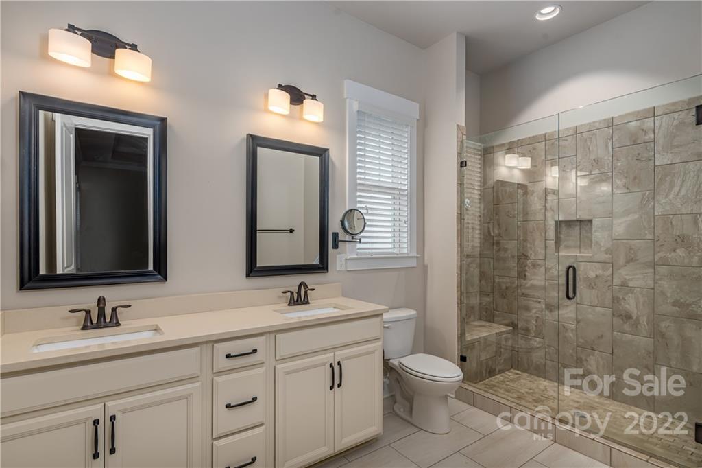807 Digby Road, Unit 227 Rock Hill, SC 29730 - Photo 27 of 36 a bathroom with a double vanity sink toilet and shower