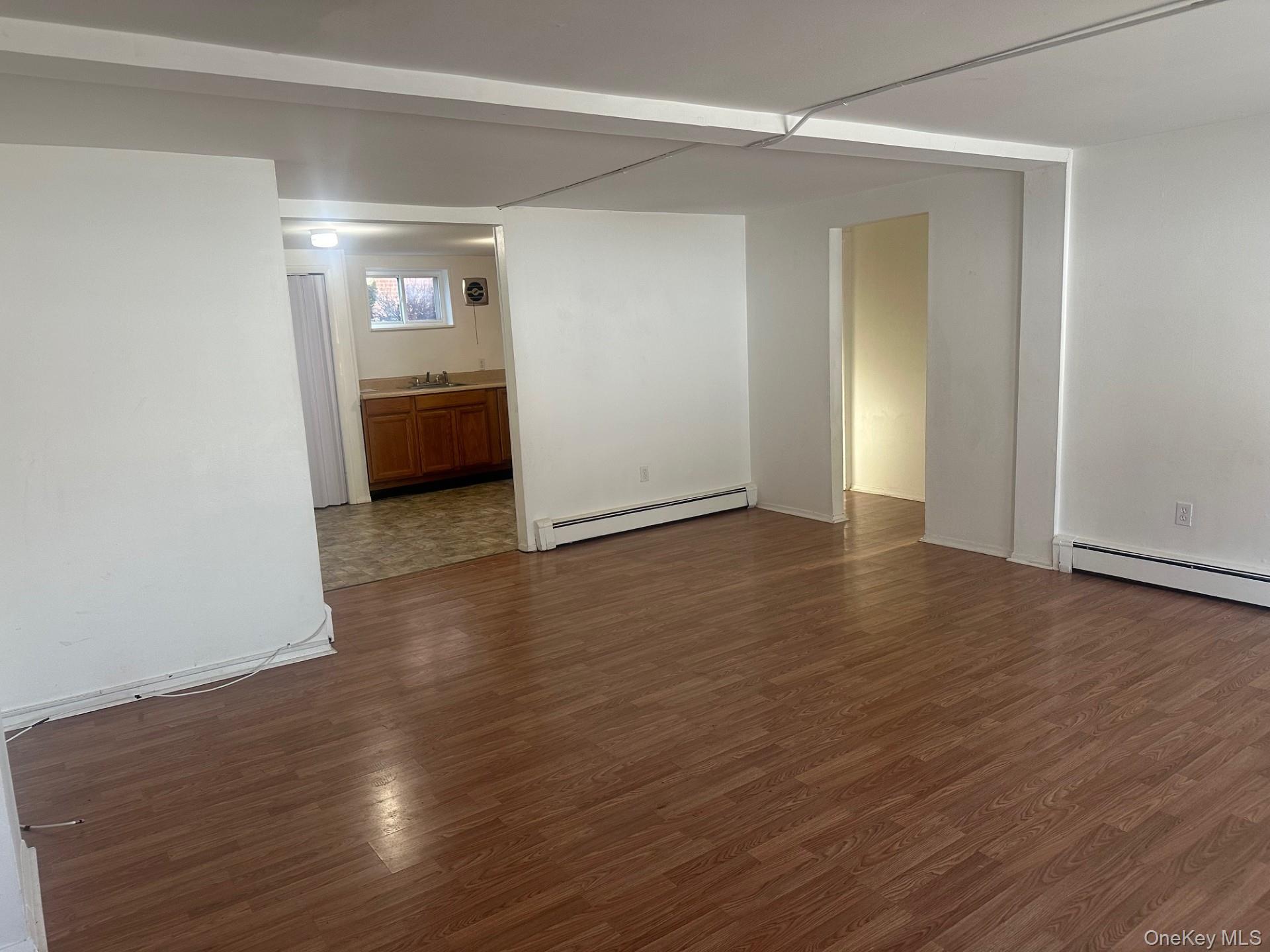 300 Ketchamtown Road, Unit C1 Wappingers Falls, NY 12590 - Photo 2 of 9 an empty room with wooden floor and windows