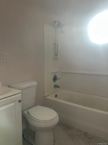 a bathroom with a toilet and a bath tub