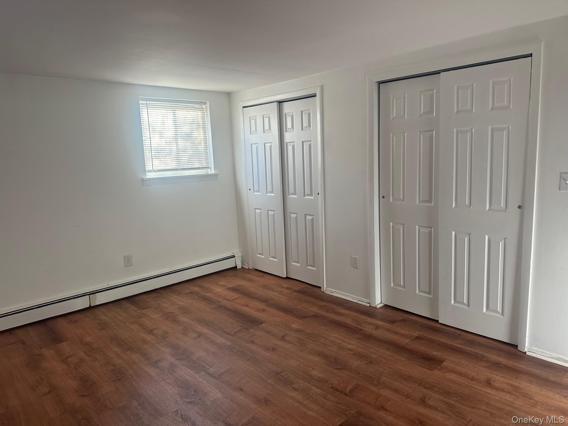 300 Ketchamtown Road, Unit C1 Wappingers Falls, NY 12590 - Photo 6 of 9 an empty room with wooden floor and windows