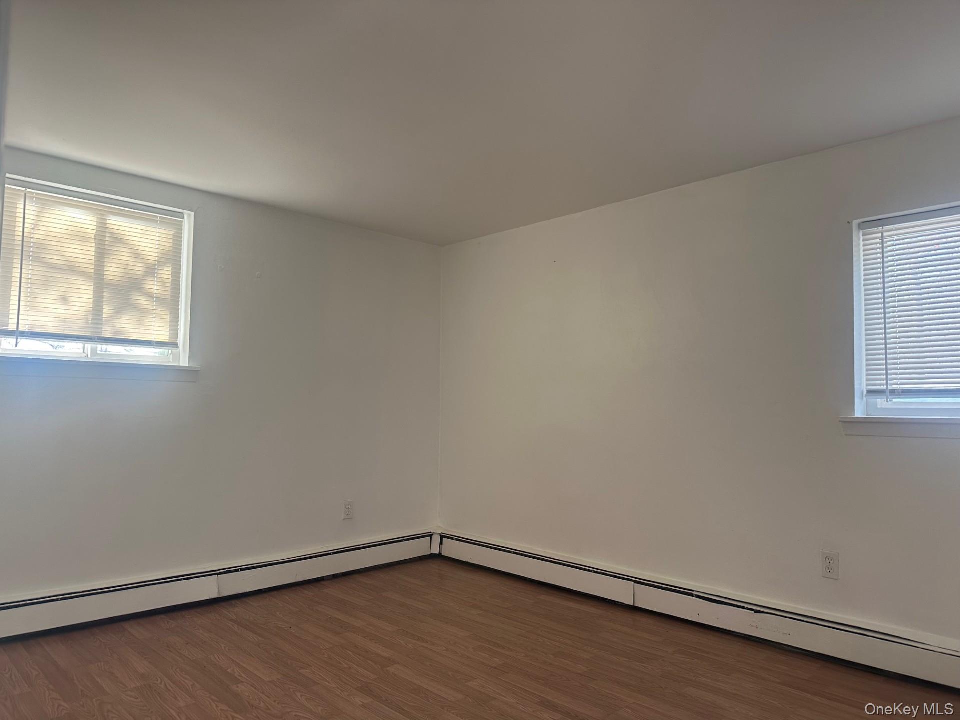 300 Ketchamtown Road, Unit C1 Wappingers Falls, NY 12590 - Photo 7 of 9 an empty room with wooden floor and windows