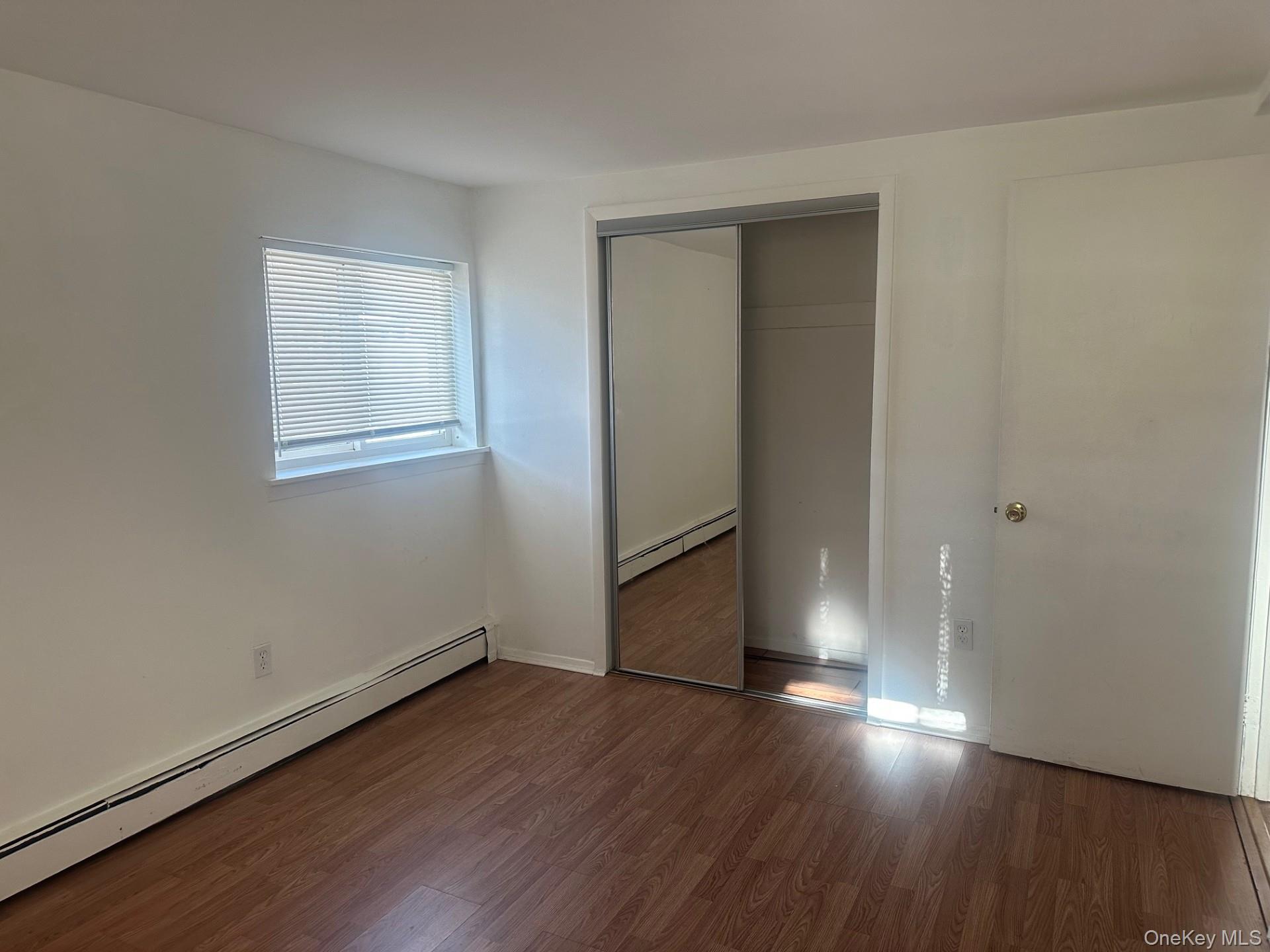 300 Ketchamtown Road, Unit C1 Wappingers Falls, NY 12590 - Photo 8 of 9 an empty room with wooden floor and windows