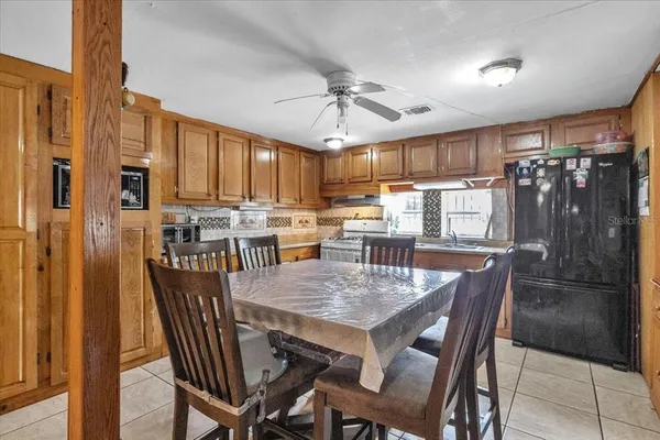 a kitchen with stainless steel appliances granite countertop a refrigerator and cabinets