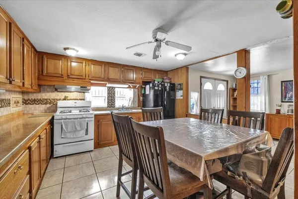 a dining area with a table chairs and entryway