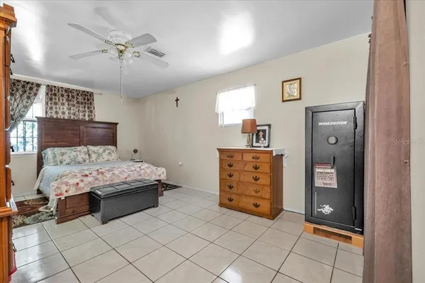 a bedroom with a bed and a couch