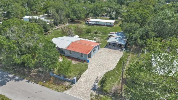 an aerial view of a house with outdoor space