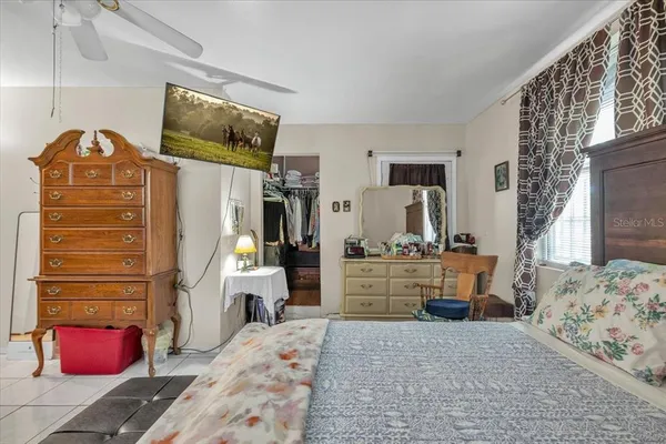 a bedroom with a bed and a chandelier