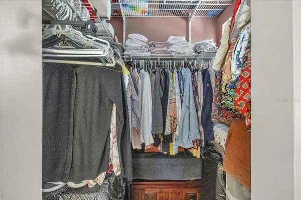 a bedroom with a bed dresser and a window