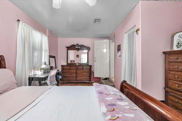 a bedroom with a bed and a chandelier