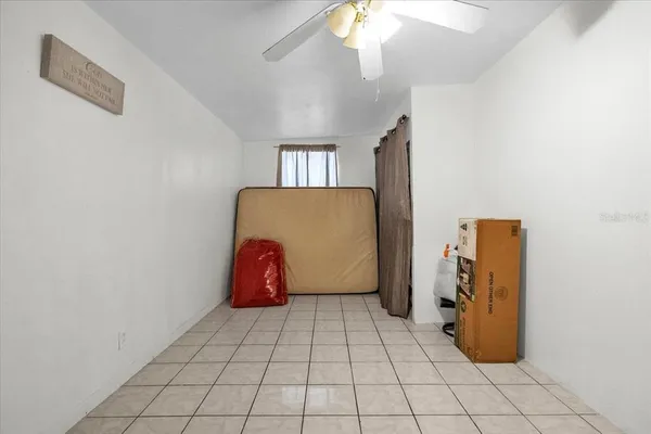 a view of a patio with table and chairs under an umbrella