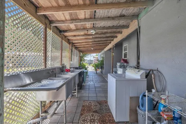 an aerial view of residential house with outdoor space and trees all around