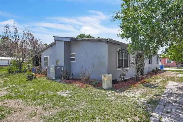 an aerial view of residential house with outdoor space and trees all around