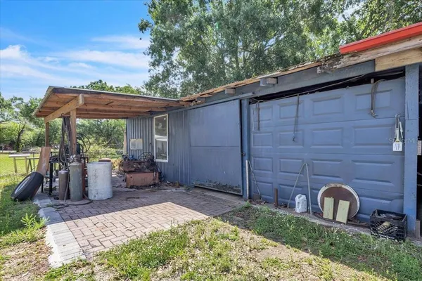 an aerial view of residential houses with outdoor space and trees