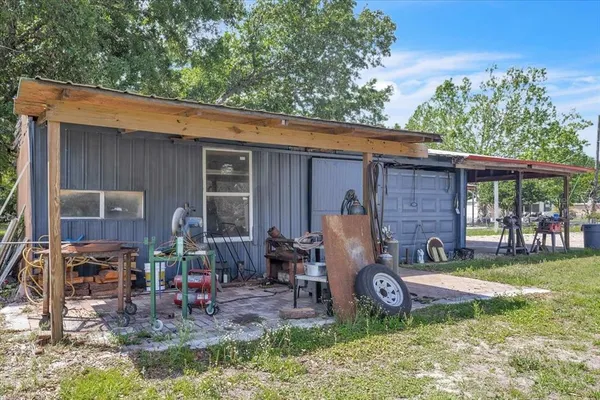an aerial view of residential houses with outdoor space and trees