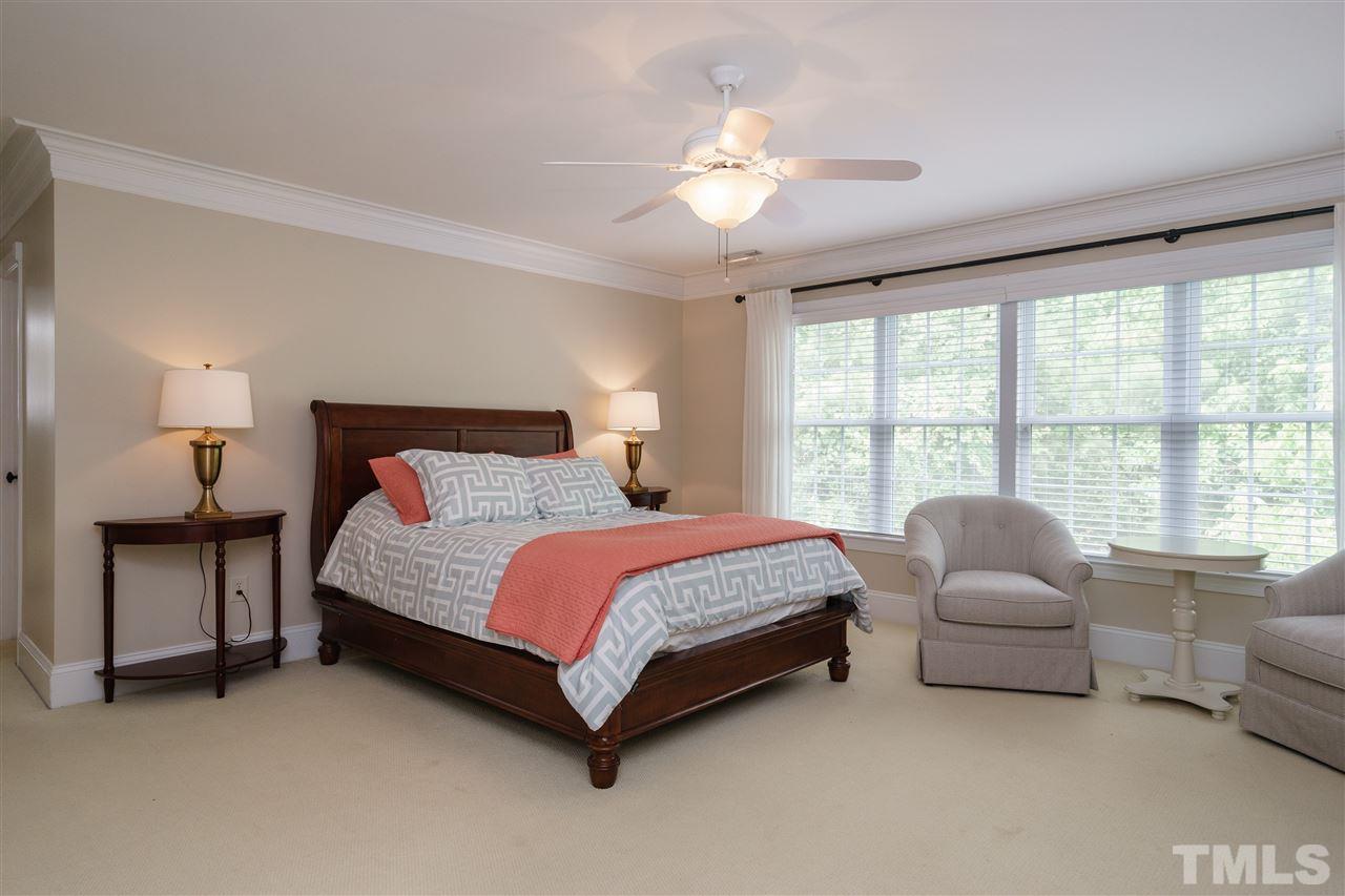 1117 Hobson Court Raleigh, NC 27607 - Photo 16 of 25 a spacious bedroom with a bed and a couch