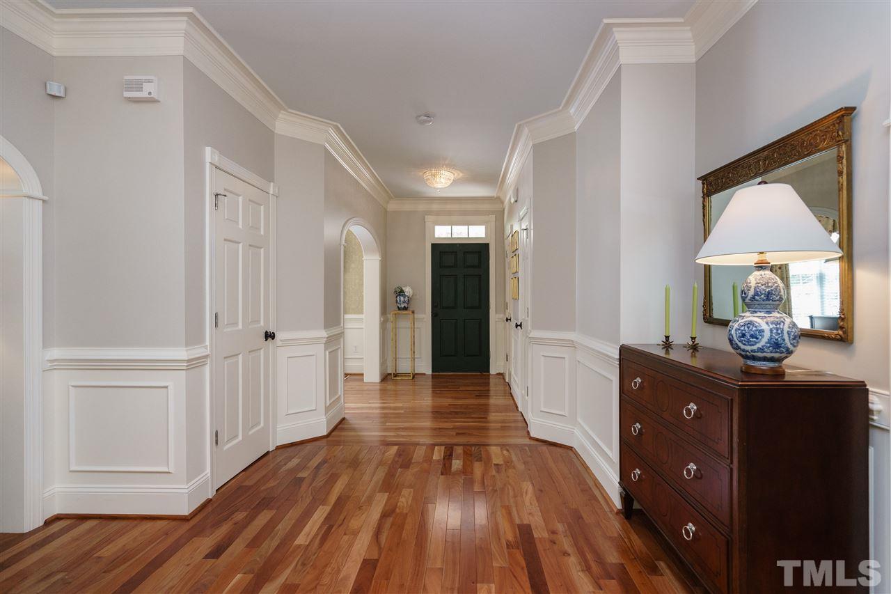 1117 Hobson Court Raleigh, NC 27607 - Photo 3 of 25 a view of a hallway with wooden floor and cabinet