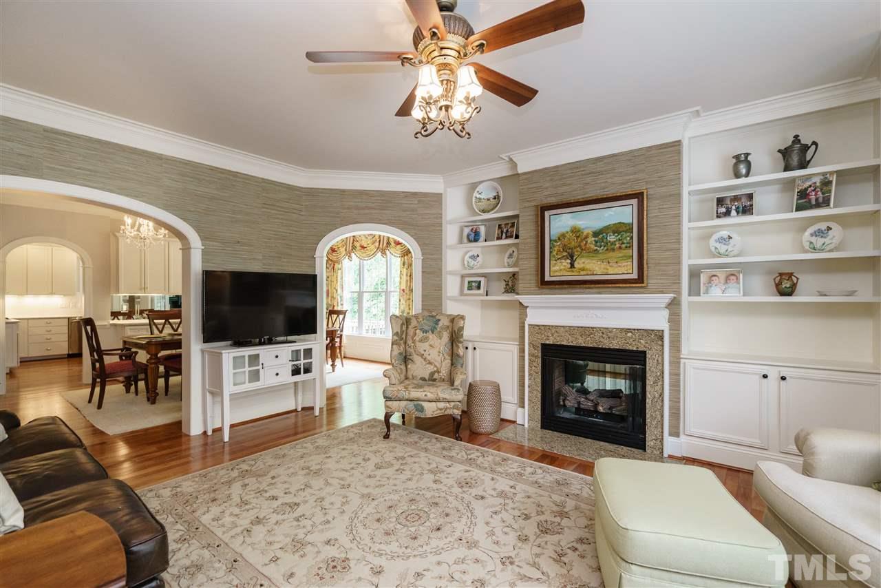 1117 Hobson Court Raleigh, NC 27607 - Photo 5 of 25 a living room with furniture a flat screen tv and a fireplace