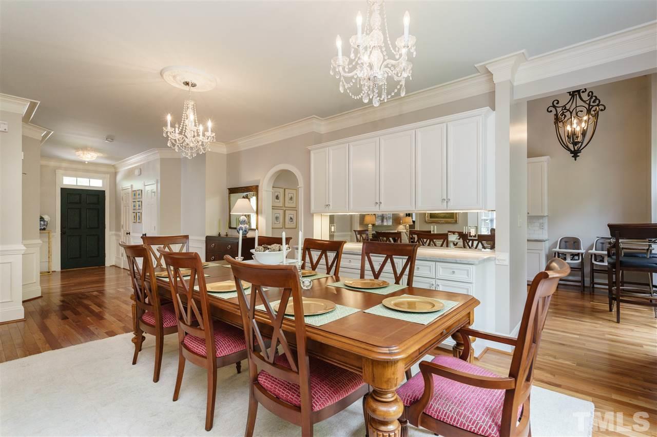 1117 Hobson Court Raleigh, NC 27607 - Photo 8 of 25 a view of a dining room with furniture a chandelier and wooden floor