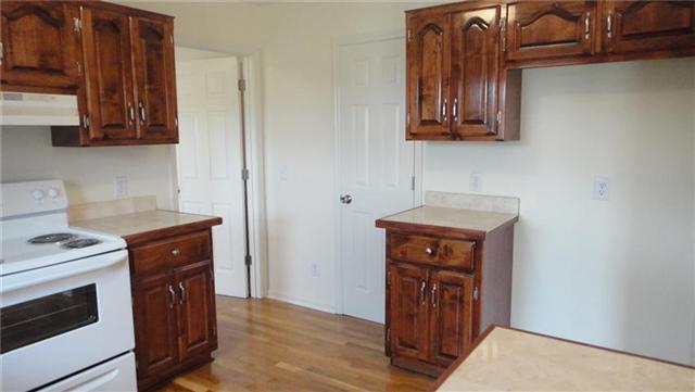 1306 Toliver Lake Road Manchester, TN 37355 - Photo 7 of 20 Kitchen boast new electric stove, new dishwasher, and newly finished hardwood.