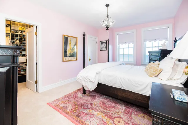 a bedroom with a bed wooden floor and window