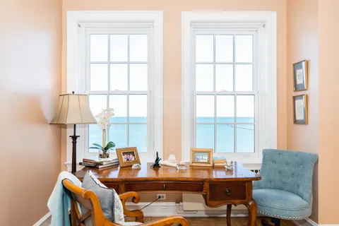 a work room with furniture and a large window