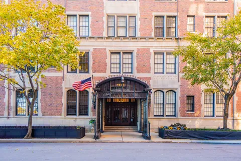 a living room with furniture a dining table and a potted plant