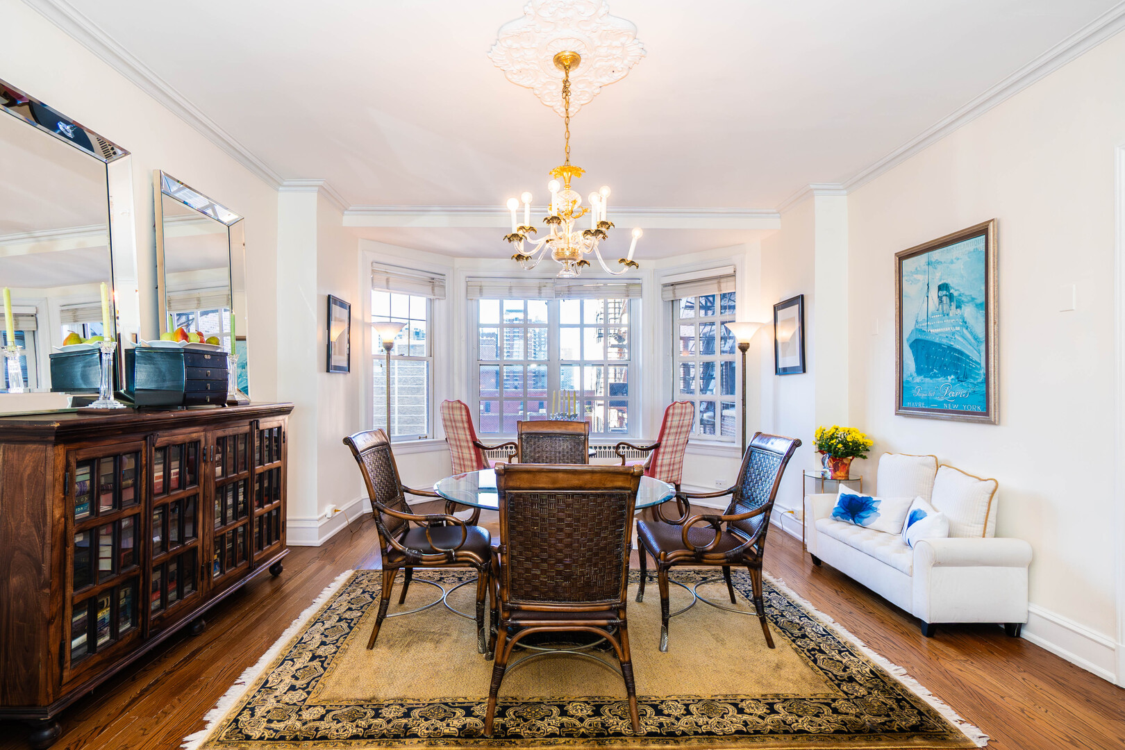 1120 North Lake Shore Drive, Unit 15A Chicago, IL 60611 - Photo 5 of 29 a dining room with furniture a chandelier and wooden floor