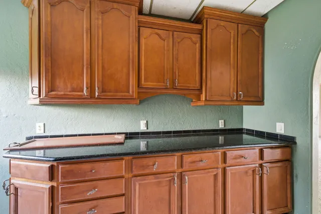a kitchen with stainless steel appliances granite countertop white cabinets and a sink