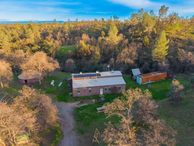 an aerial view of a house with a yard