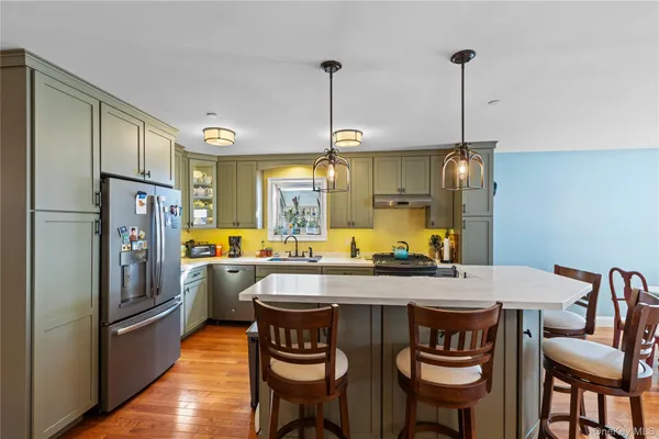 a kitchen with a table chairs refrigerator and microwave