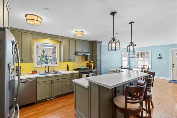 a kitchen with a sink a stove and chairs