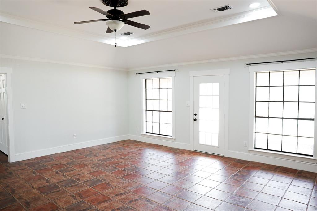10575 Friendship Road Pilot Point, TX 76258 - Photo 20 of 32 Spacious room featuring tile flooring, a tray ceiling with a ceiling fan, and recessed lighting