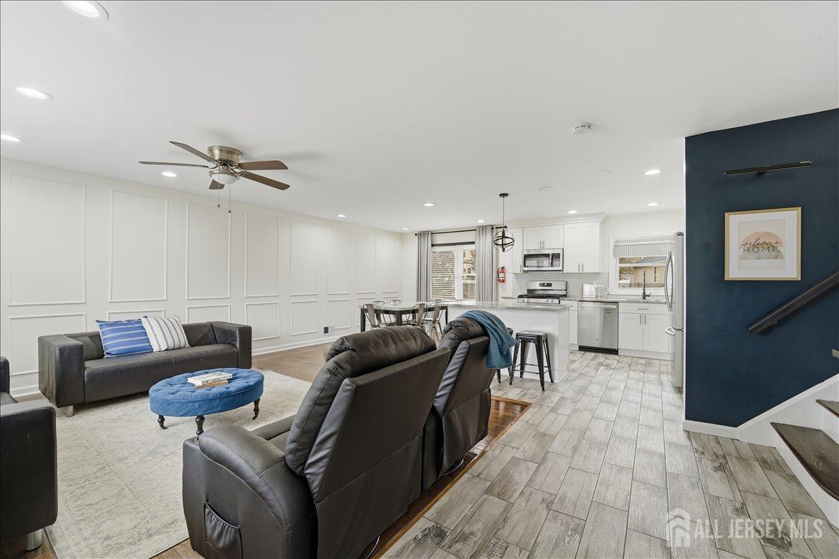 a living room with furniture and kitchen view